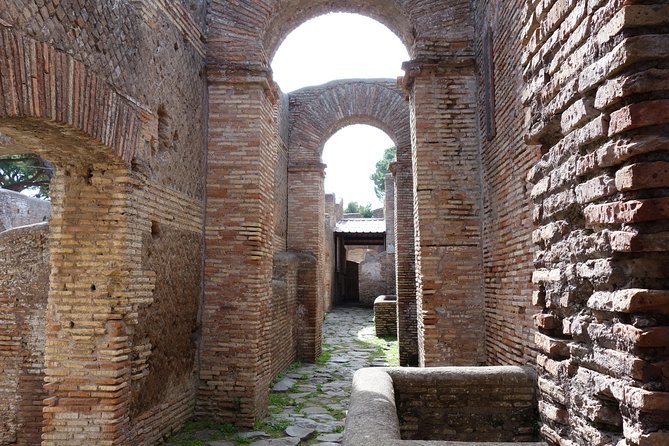 Ancient Ostia Antica Semi-Private Day Trip from Rome by Train with Guide - The amphitheater and the Forum of the Corporations