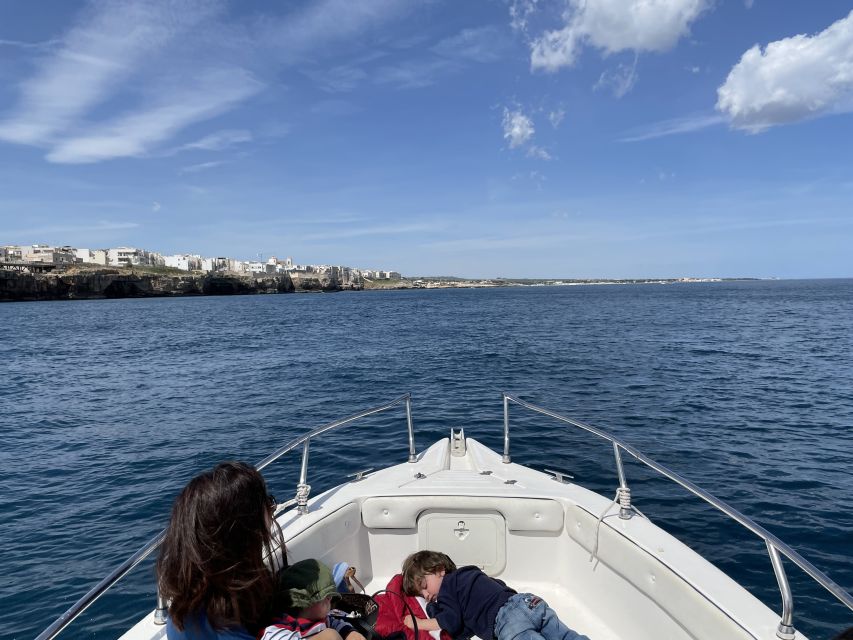 Polignano a Mare: Speedboat Cruise to Caves with Aperitif - Domenico Modugno and the view toward town