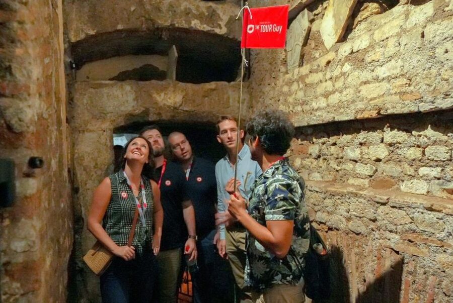 Rome: Catacombs and Capuchin Crypt Guided Tour with Transfer - Walking through an ancient catacomb